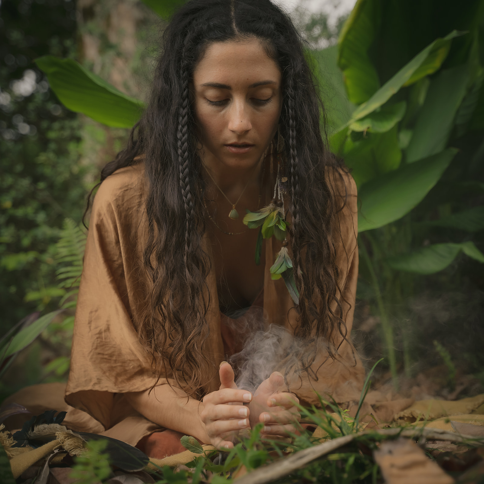Mia in a quiet ceremonial moment in the forest